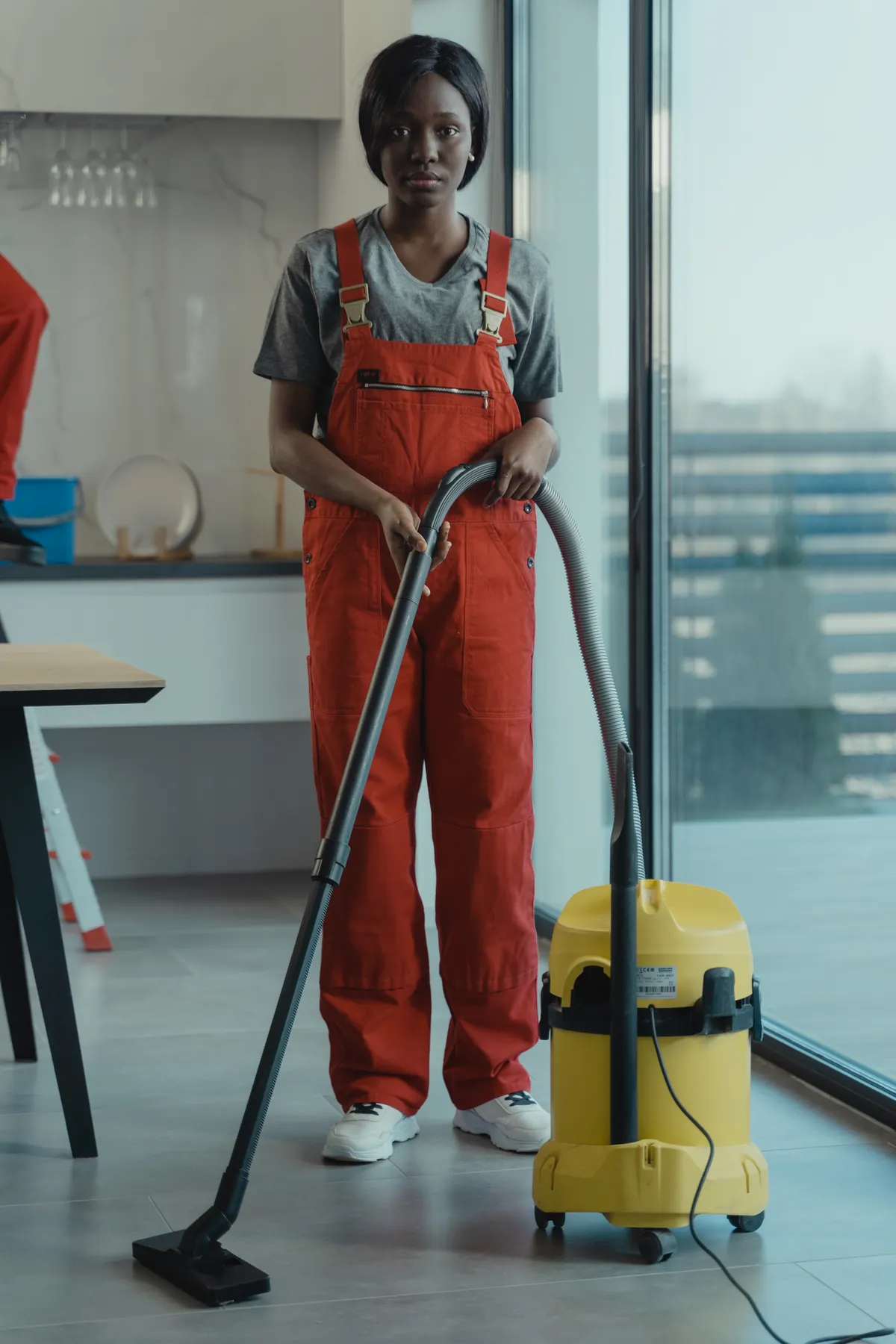 Janitorial technician vacuuming an office
