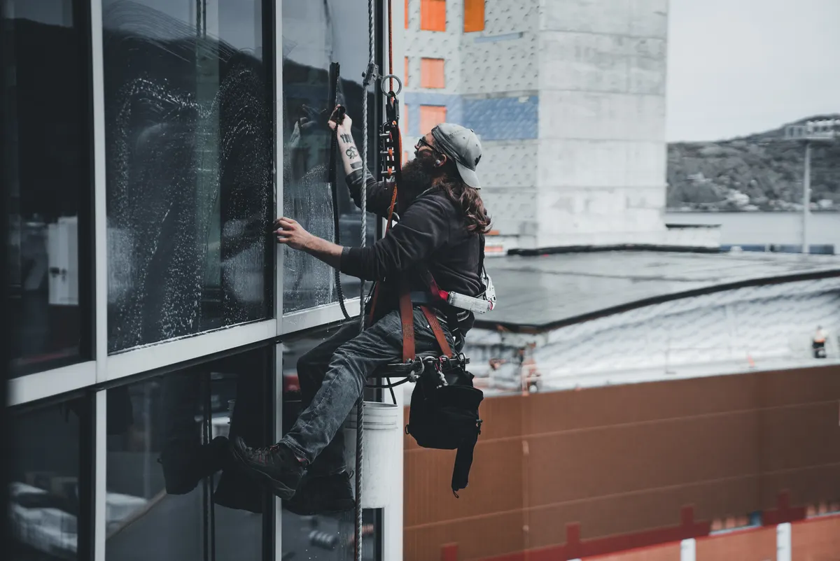 Window cleaner working on a high-rise facade